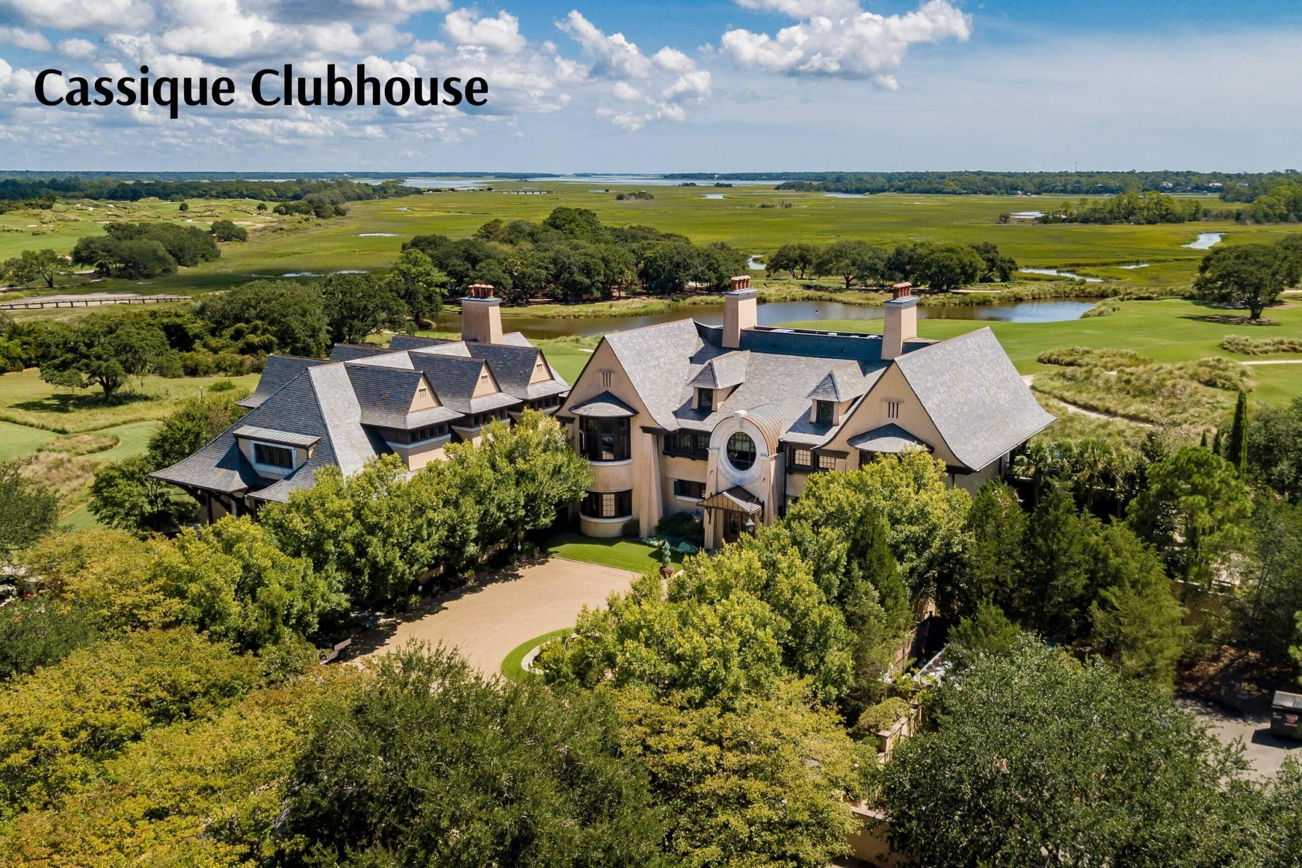 Cassique Clubhouse at Kiawah Island surrounded by lush greenery, featuring Lowcountry architecture and private golf course views.