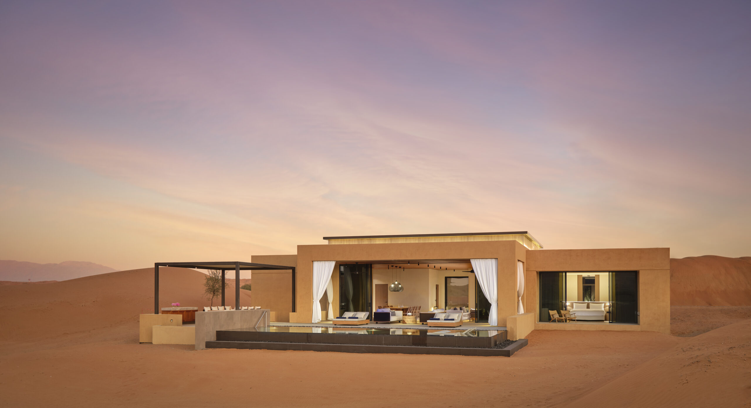 Villa Exterior, on a sandy dessert. Sunset in back.
