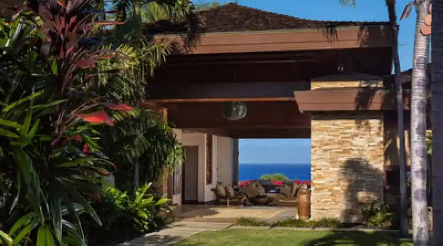Interior courtyard features colorful landscaping with paved walkways to the main entry, guest bedroom and separate media room.
