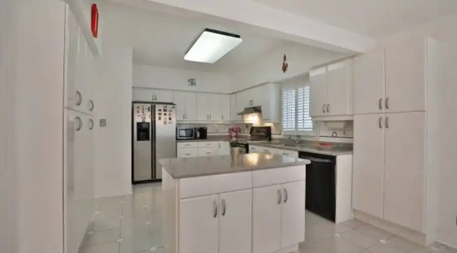 Bright white kitchen with huge eat in area