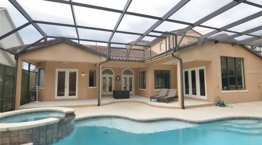 Covered Outdoor Dining. Access to Caged Pool from Living Room, Family Room, Kitchen and Master Bedroom!