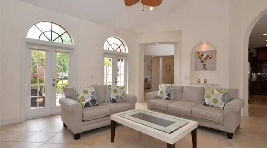 Living Room with view of Front Court Yard through Arched French Doors!