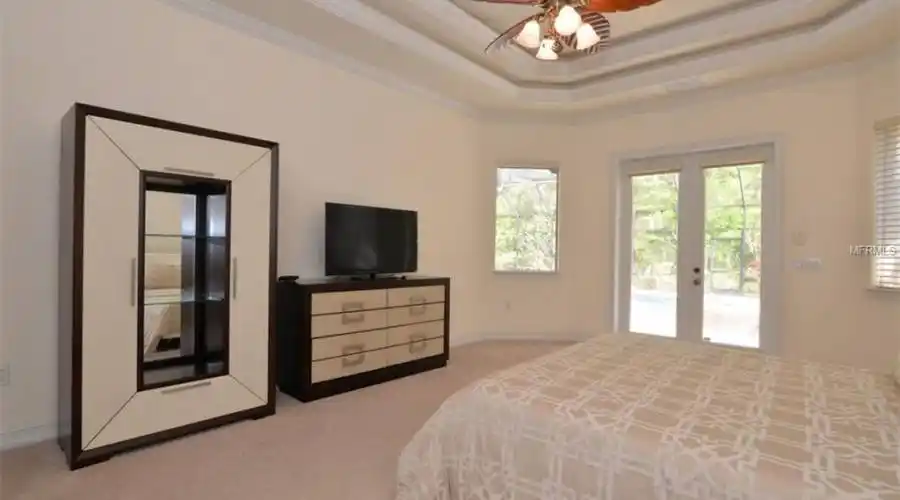 Master Bedroom with Tray Ceiling and Beautiful View and access to Pool Oasis