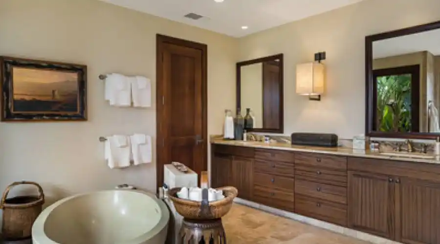 Master bathroom provides a large oval concrete tub that looks out to the lush outdoor shower garden.