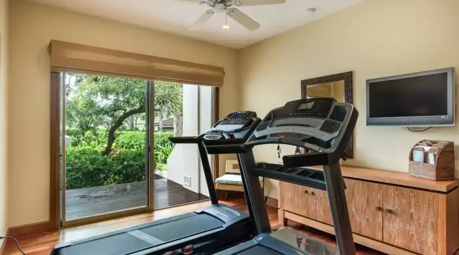 Additional lower level guest bedroom features a private deck overlooking garden views.